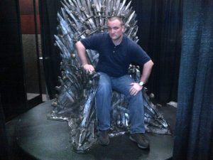 Ryan Alford sitting on the "Throne of Swords" at the 2013 SXSWi.